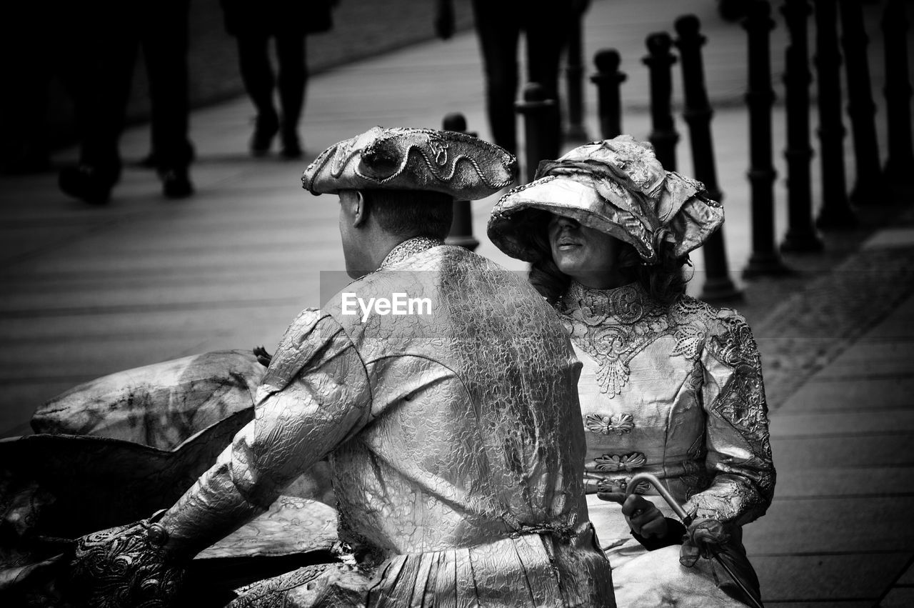 Street performers dressed as stone statues