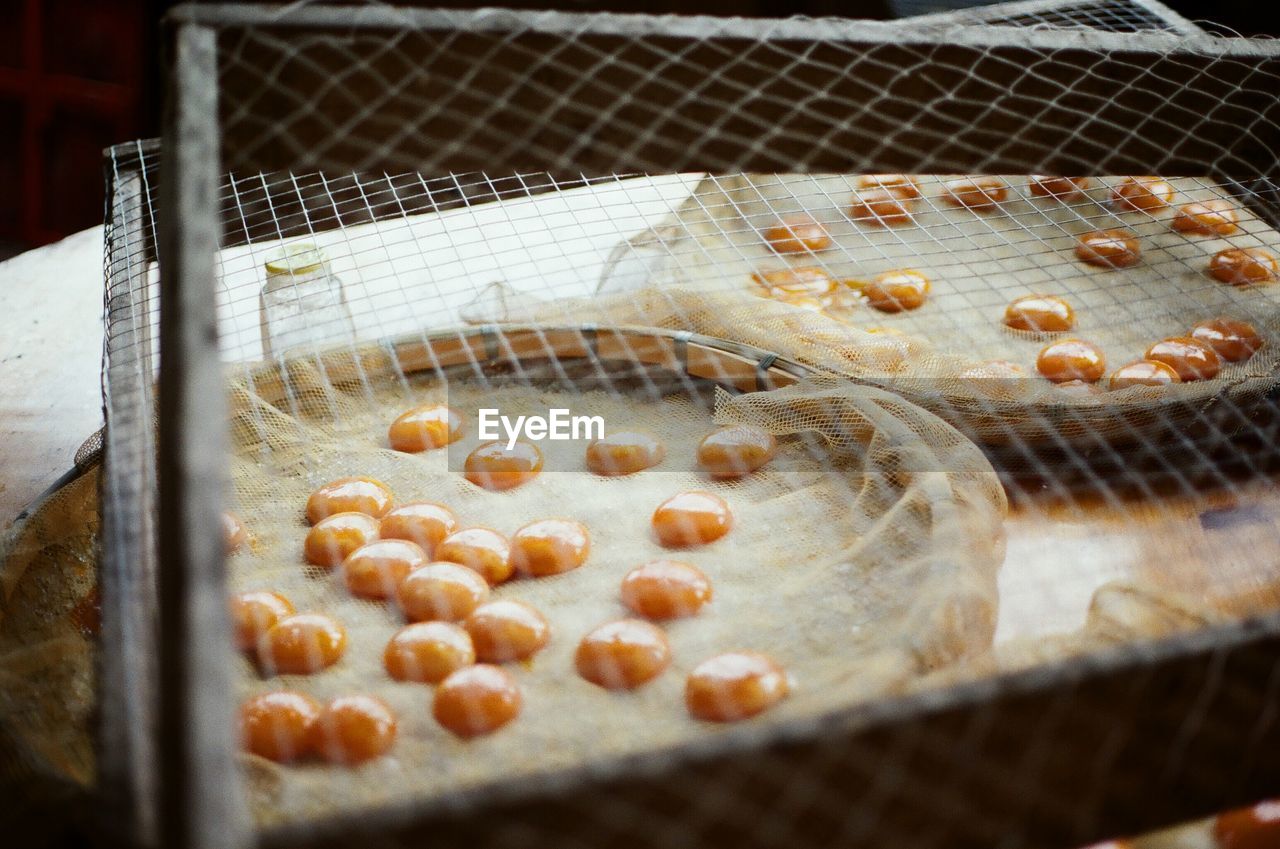 High angle view of fresh egg yolks in containers