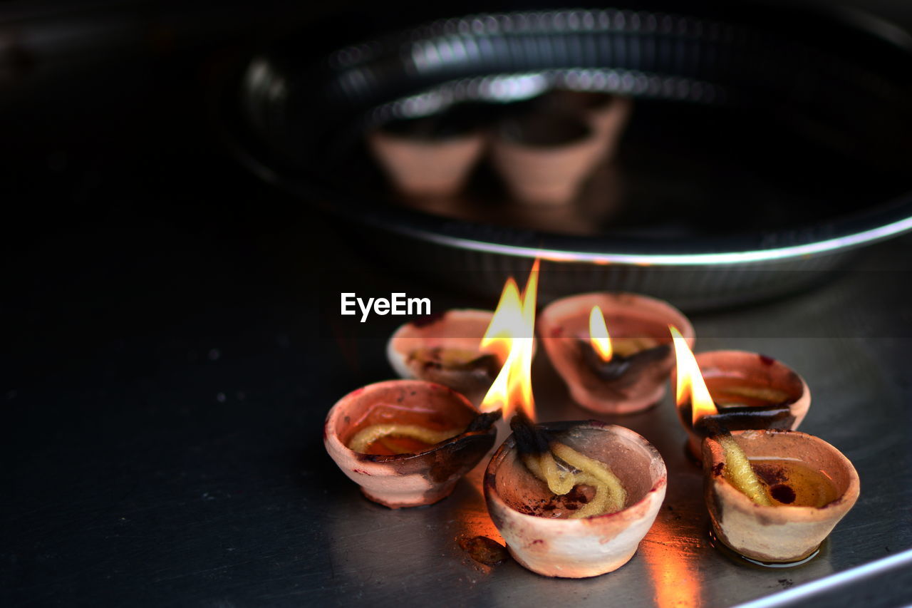 CLOSE-UP OF BURNING CANDLES