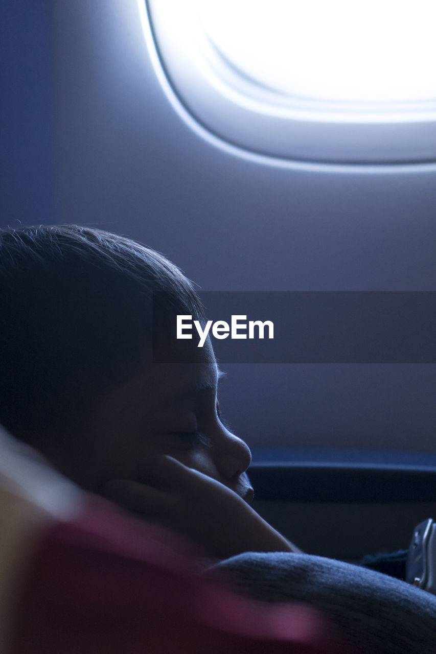 Close-up of boy sleeping in airplane