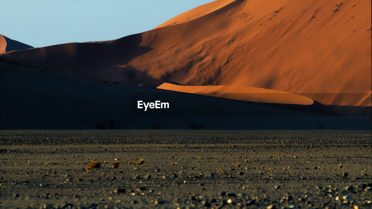 Scenic view of desert against sky during sunset