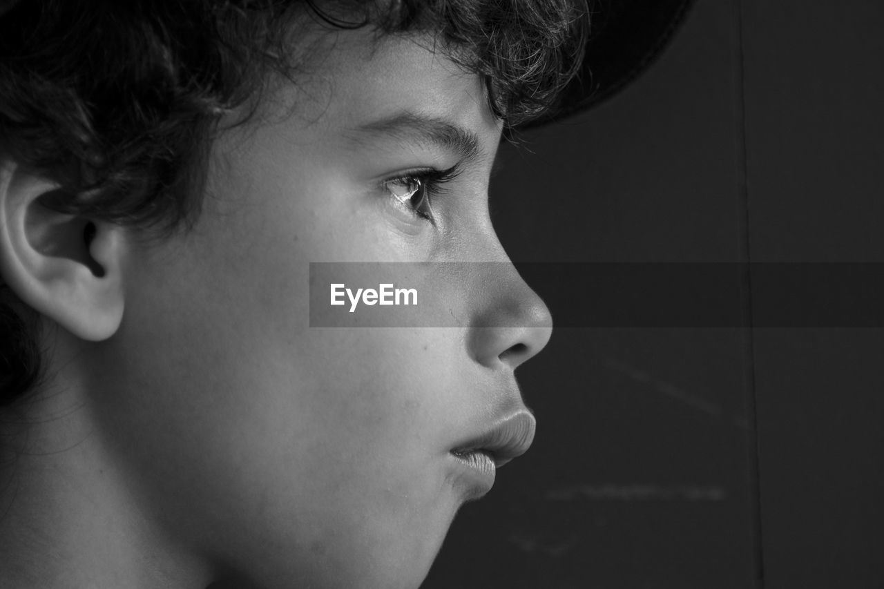 Close-up of boy against wall