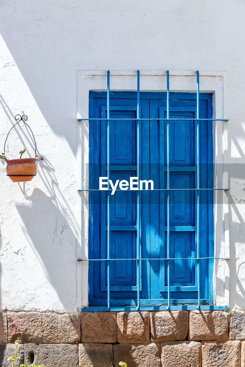 Closed blue door of house on sunny day