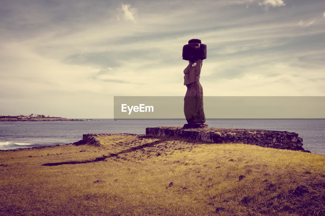 STONE STANDING ON ROCK BY SEA