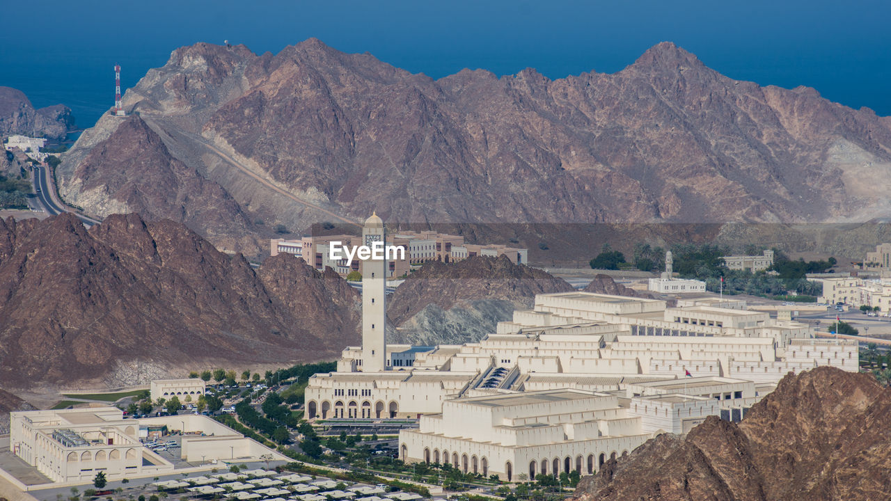 Oman parliament buildings in city against mountain range