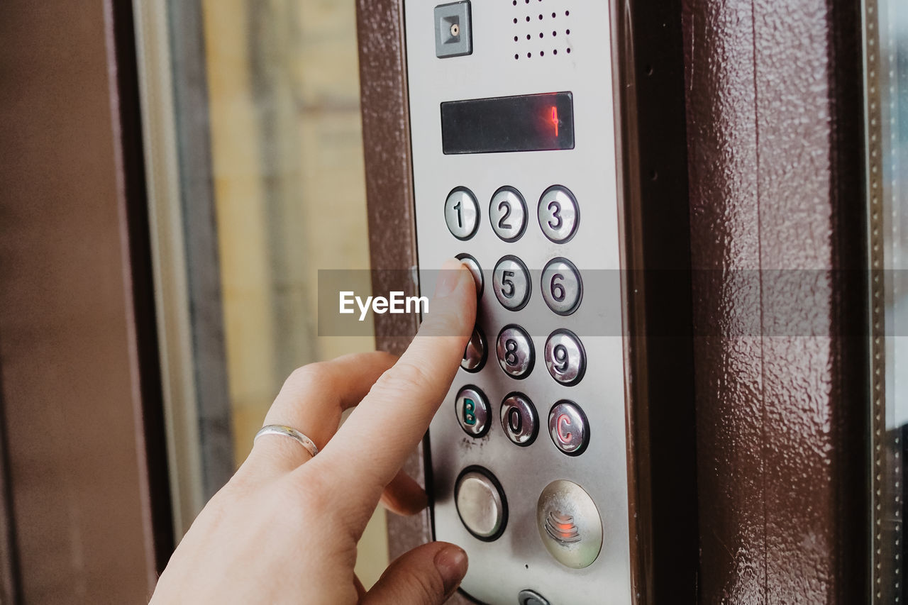 Woman typing pin code to unlock smart electronic digital code door. high quality photo