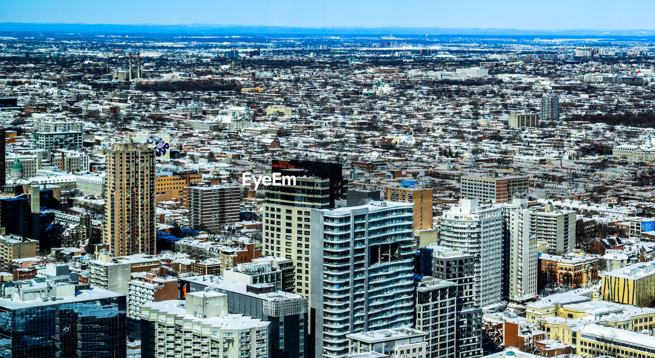 High angle view of modern buildings in city against sky