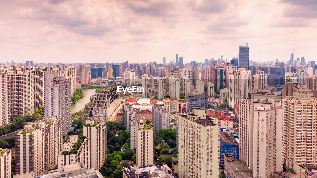 High angle view of modern buildings in city against sky