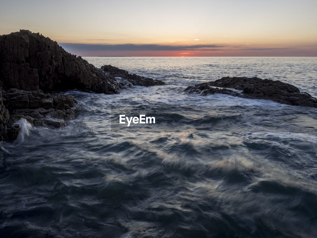 Scenic view of sea against sky during sunset