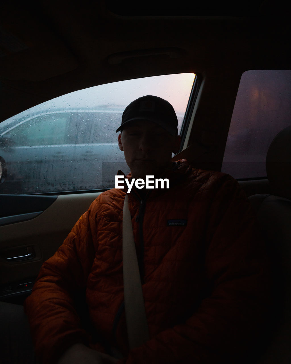 MAN SITTING ON CAR WINDOW