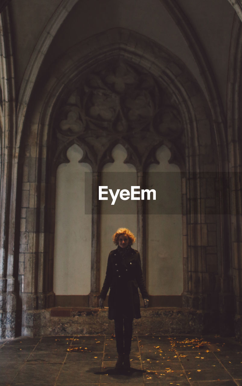 Full length of woman standing in historic church