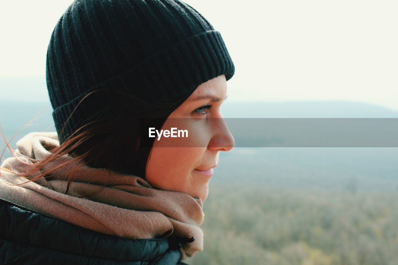 Close-up portrait of young woman looking away