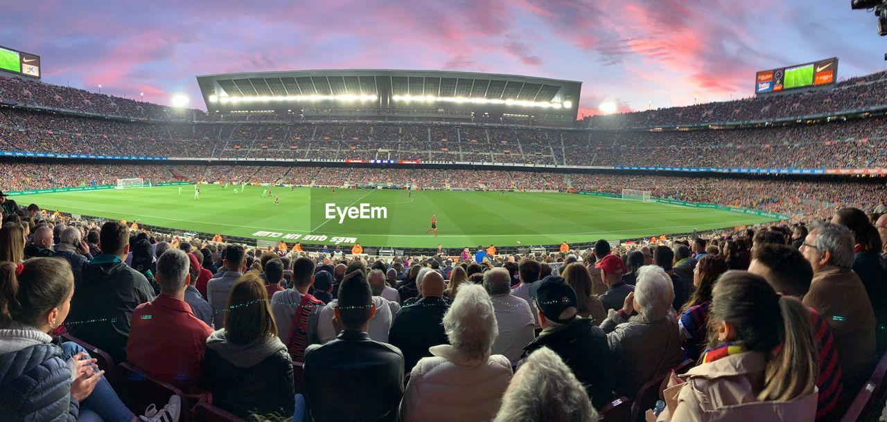 GROUP OF PEOPLE LOOKING AT STADIUM