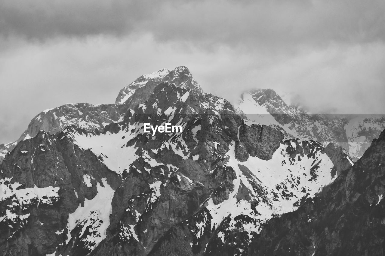 mountain, black and white, environment, scenics - nature, cloud, snow, sky, landscape, mountain range, beauty in nature, monochrome, cold temperature, monochrome photography, snowcapped mountain, winter, nature, mountain peak, travel, travel destinations, no people, rock, outdoors, summit, extreme terrain, non-urban scene, land, panoramic, tranquility, day, ridge, tourism, physical geography, tranquil scene