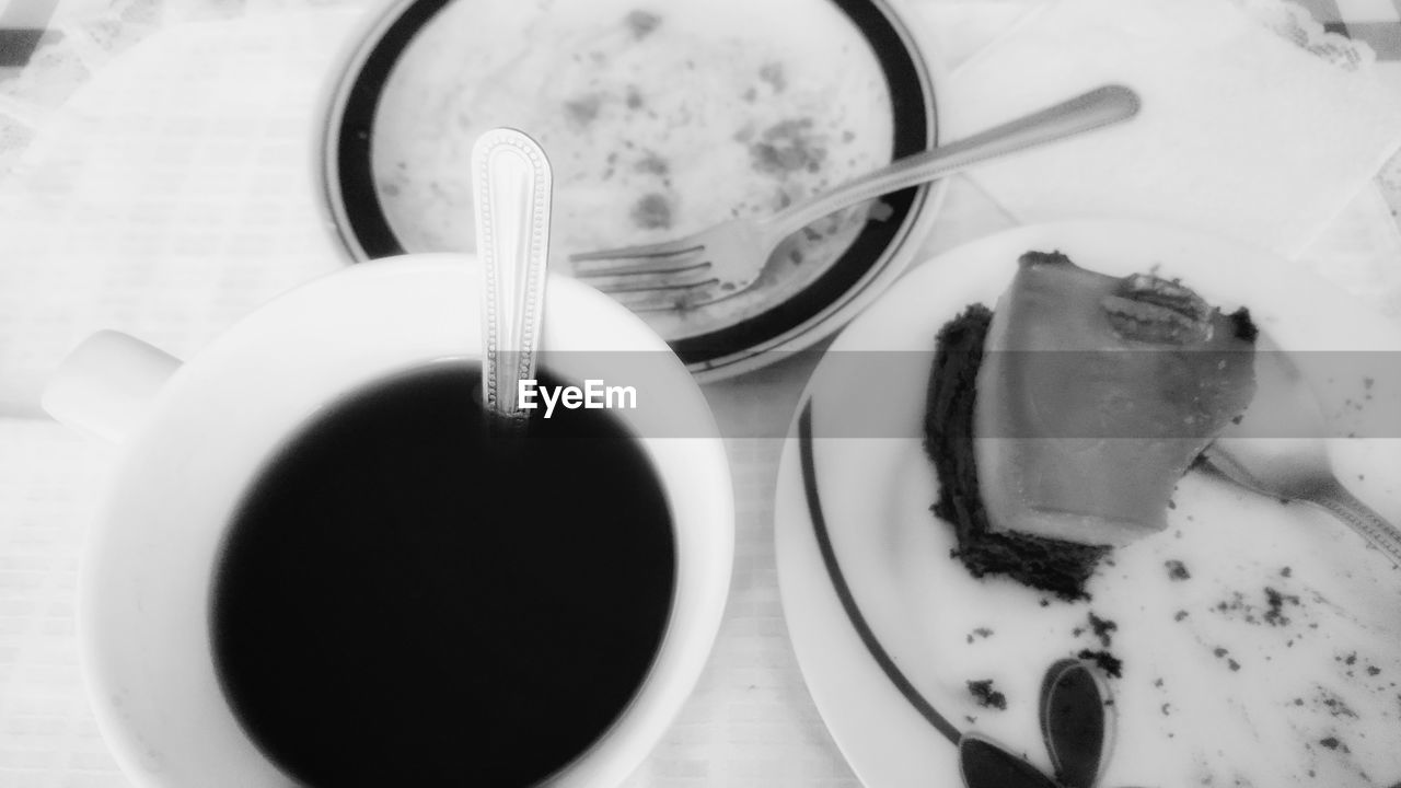 CLOSE-UP OF COFFEE CUP ON TABLE WITH SPOON