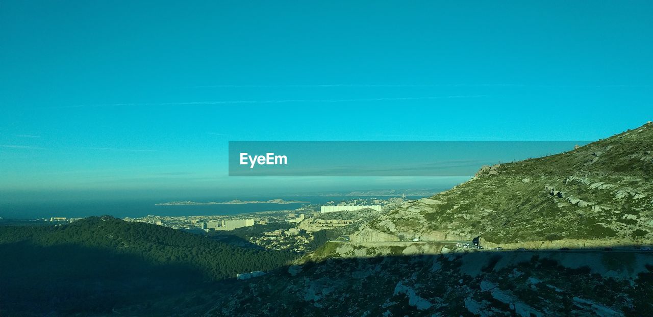 Scenic view of mountains against clear blue sky