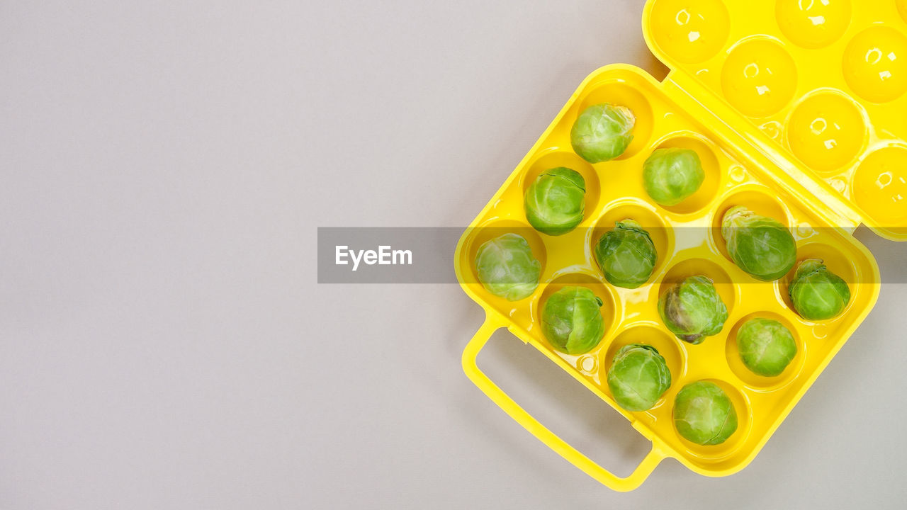 yellow, studio shot, food and drink, indoors, green, food, no people, copy space, healthy eating, produce, high angle view, still life, freshness, fruit, wellbeing, close-up, directly above, flower