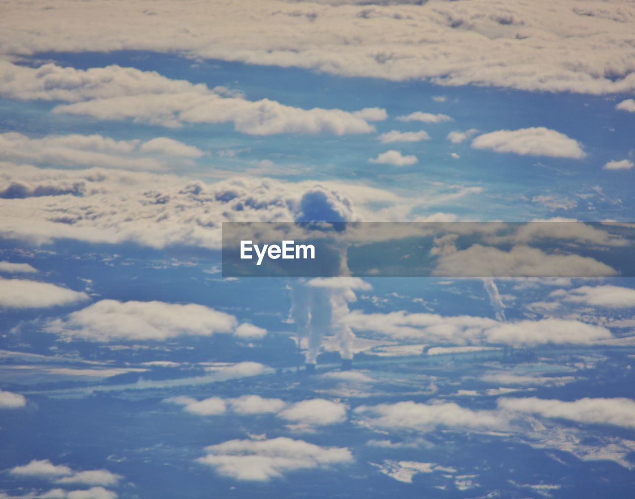 Aerial view of landscape against cloudy sky