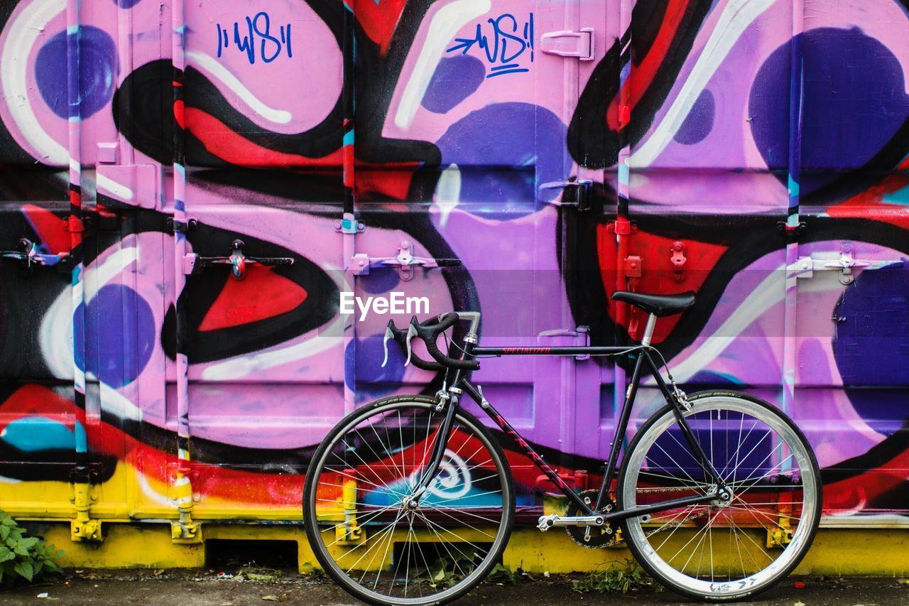 CLOSE-UP OF MULTI COLORED BICYCLE PARKED