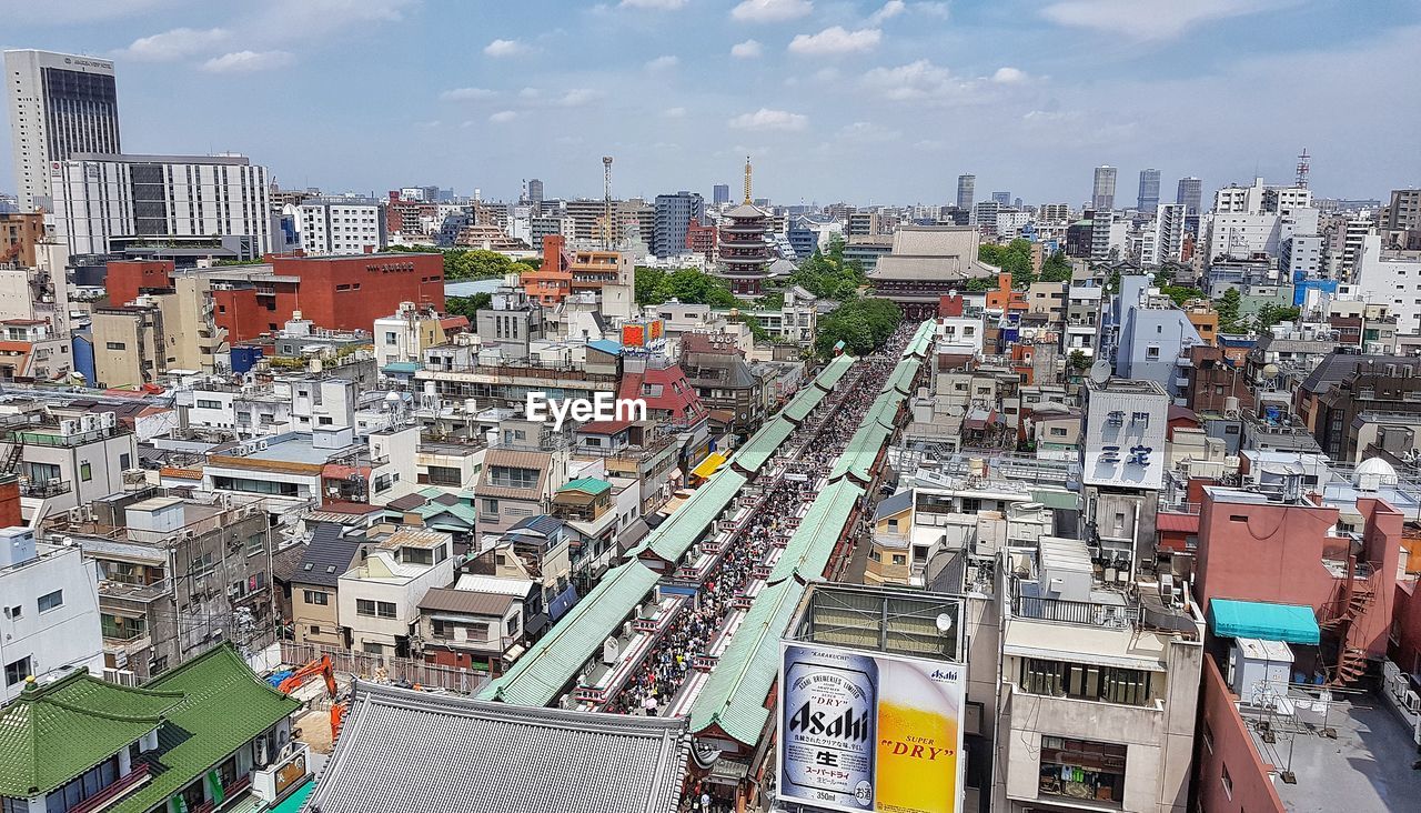 HIGH ANGLE VIEW OF STREET AND BUILDINGS AGAINST SKY