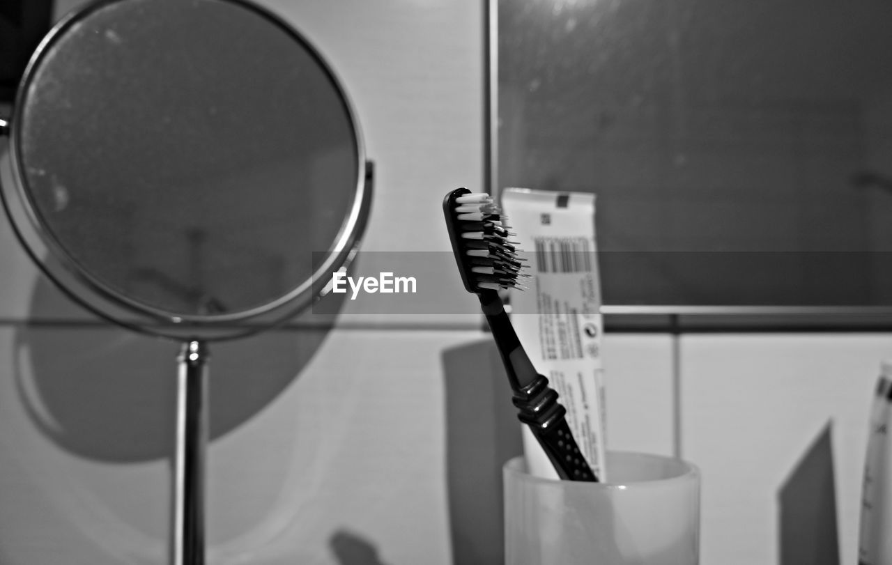 Close-up of toothbrush and toothpaste in bathroom