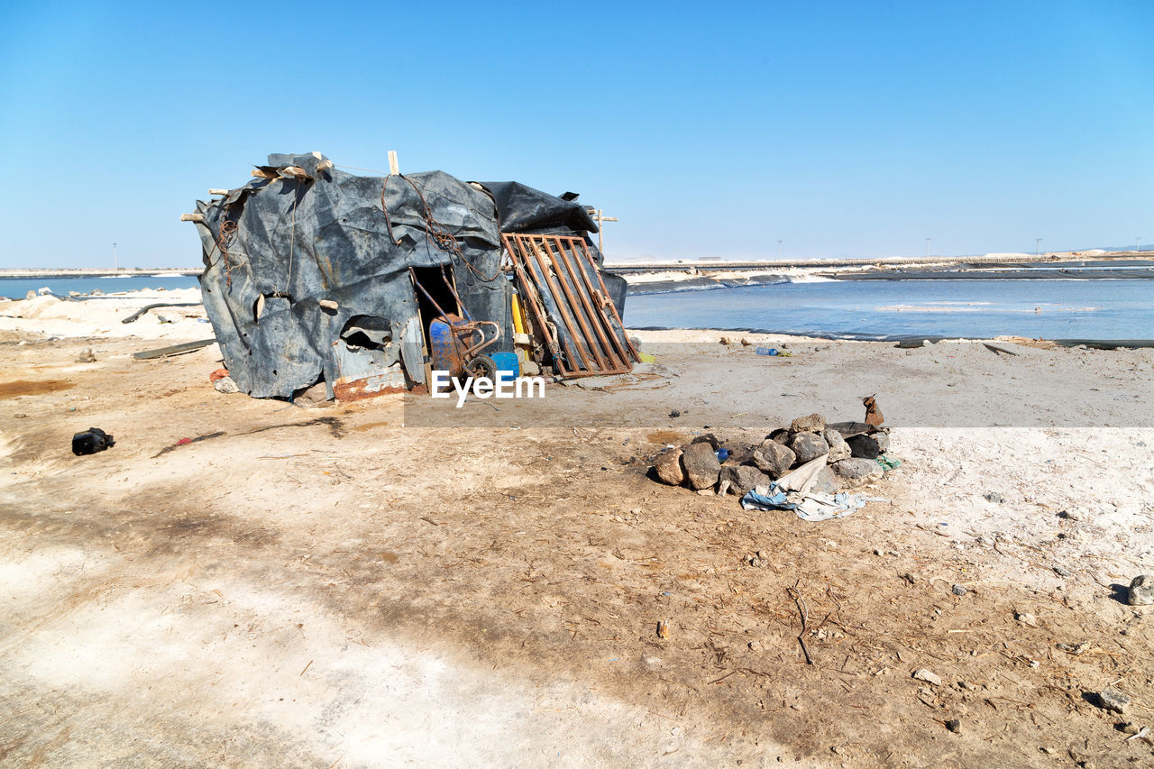 GRAFFITI ON SHORE AGAINST CLEAR SKY