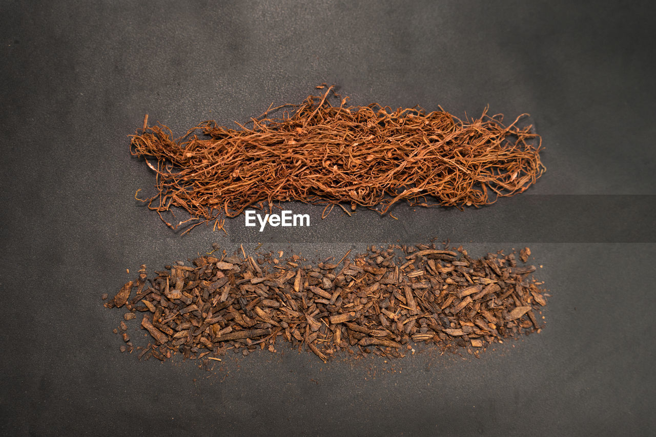 Ciggarette dried tobacco isolated on dark background