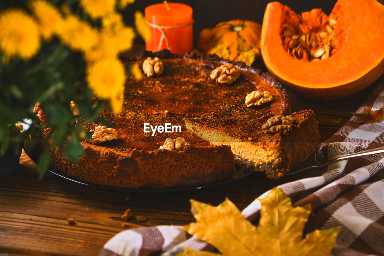 Traditional pumpkin pie with walnuts and ingredients