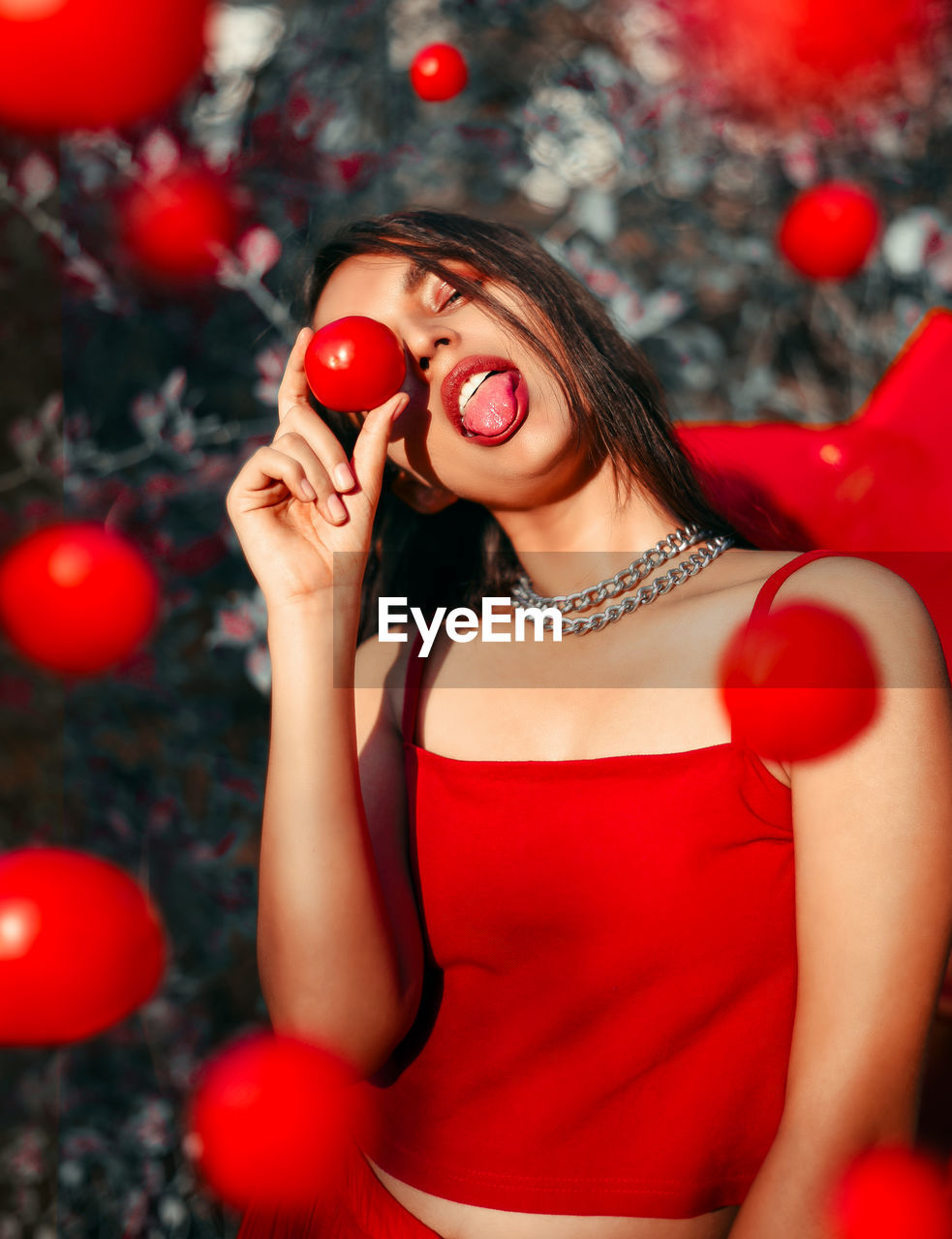  young woman holding a tomato