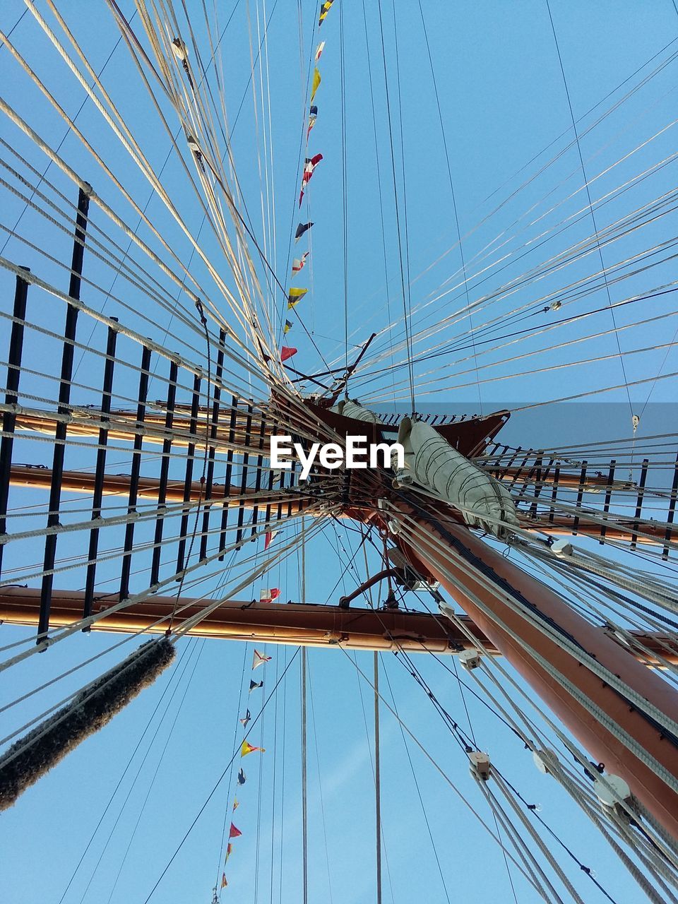 Low angle view of sailboat sailing against clear blue sky