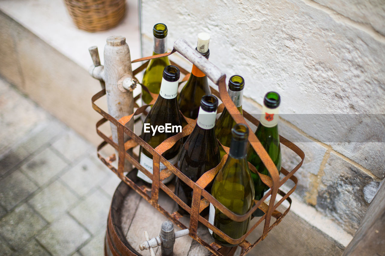 High angle view of wine bottles in metal crate