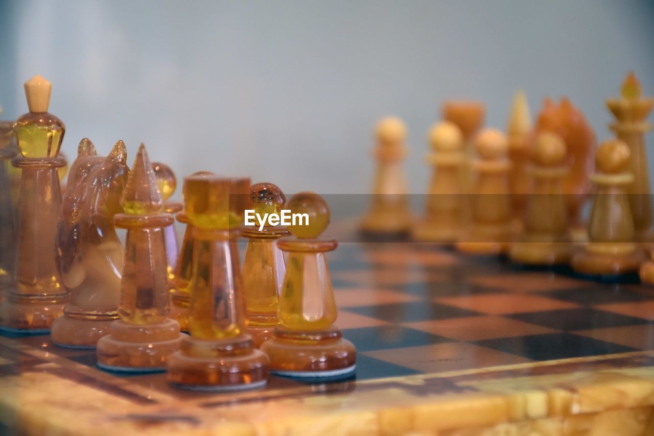CLOSE-UP OF CHESS PIECES ON TABLE AT HOME