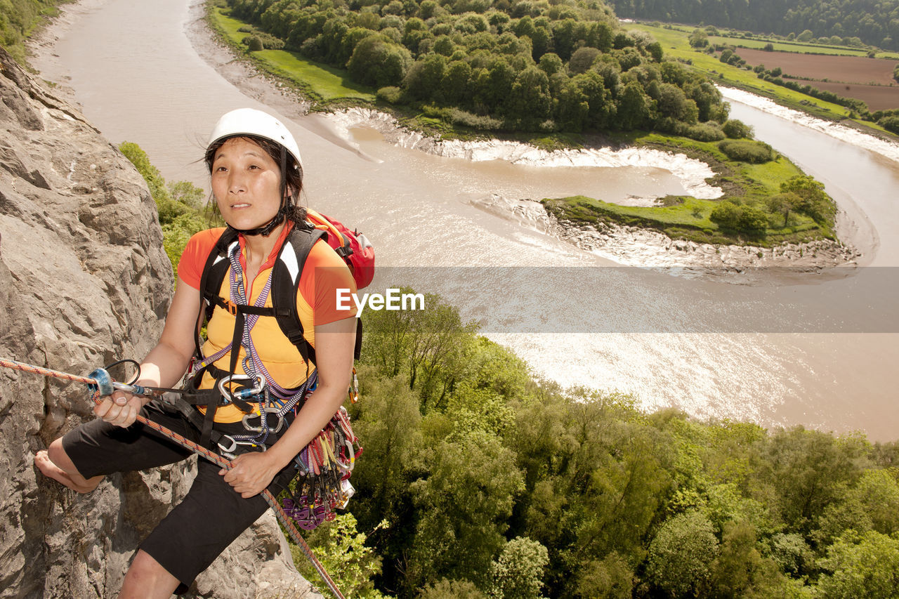 Woman rappelling of cliff in south wales