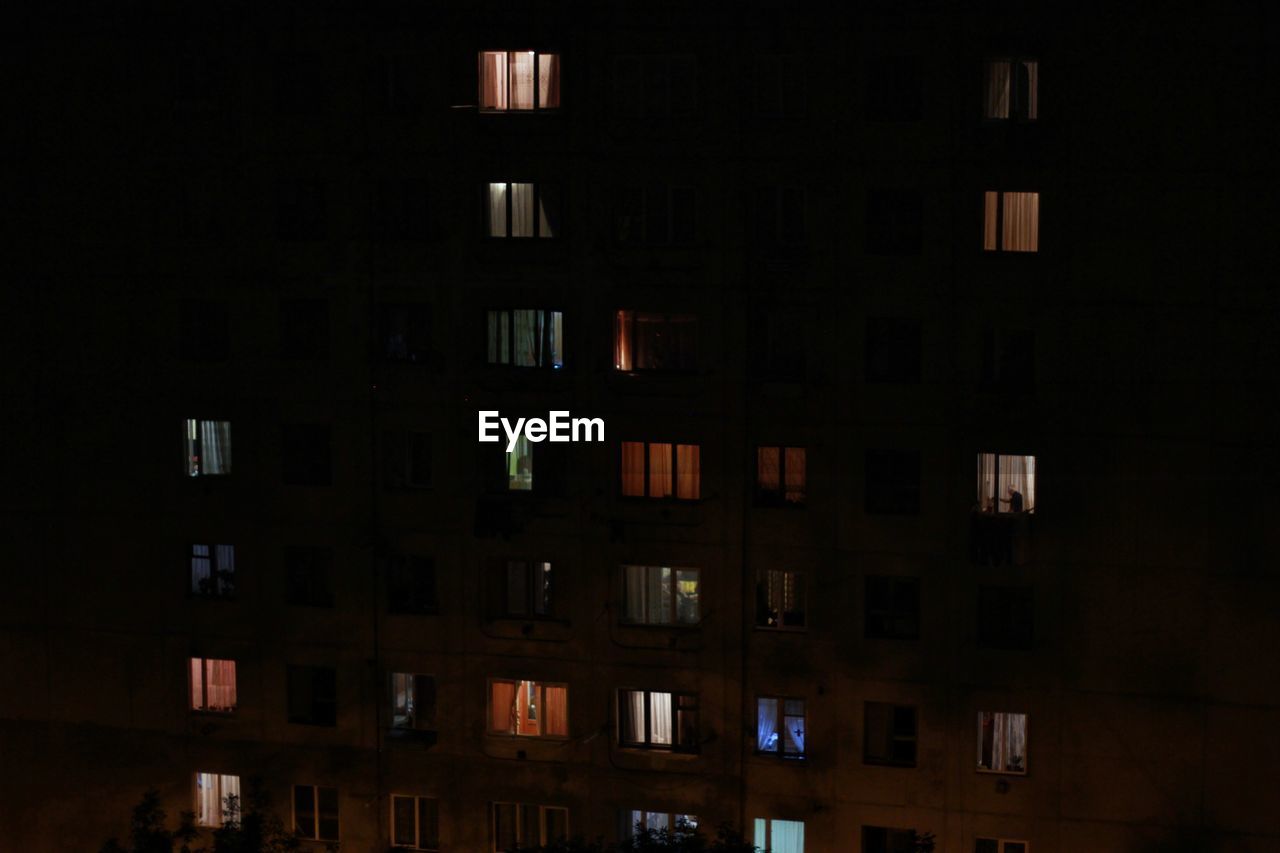 low angle view of illuminated buildings in city at night