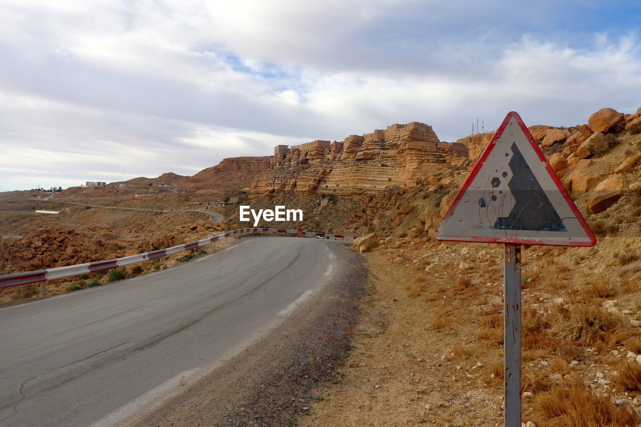 Road sign against mountain