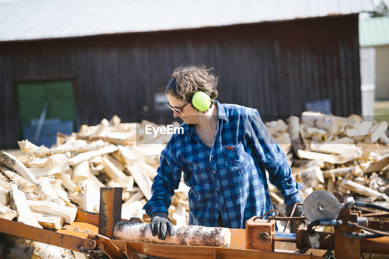 Mature woman working in sawmill