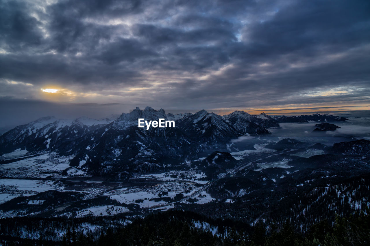 Scenic view of snowcapped mountains against sky during sunset