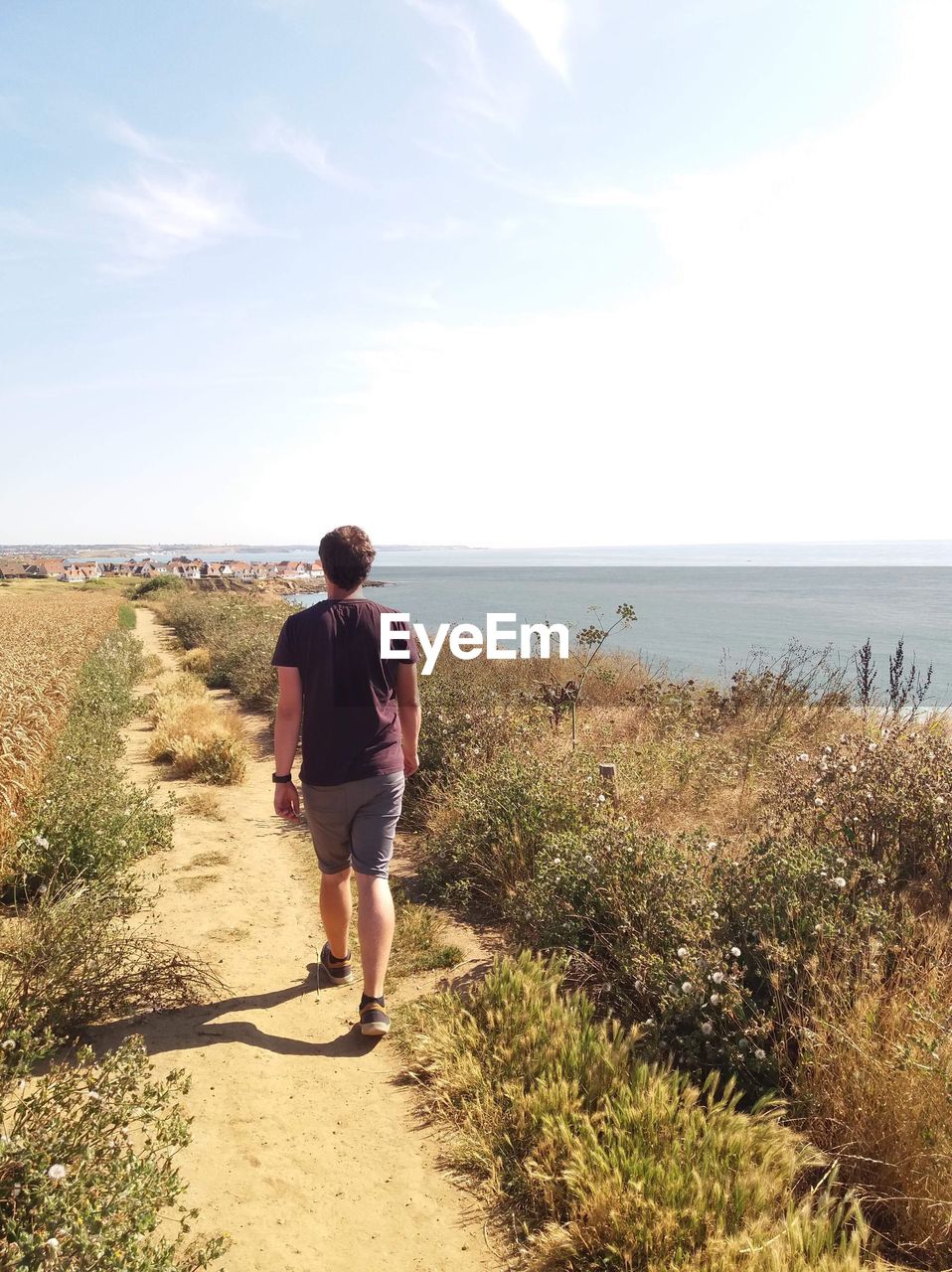 Rear view full length of man walking at beach