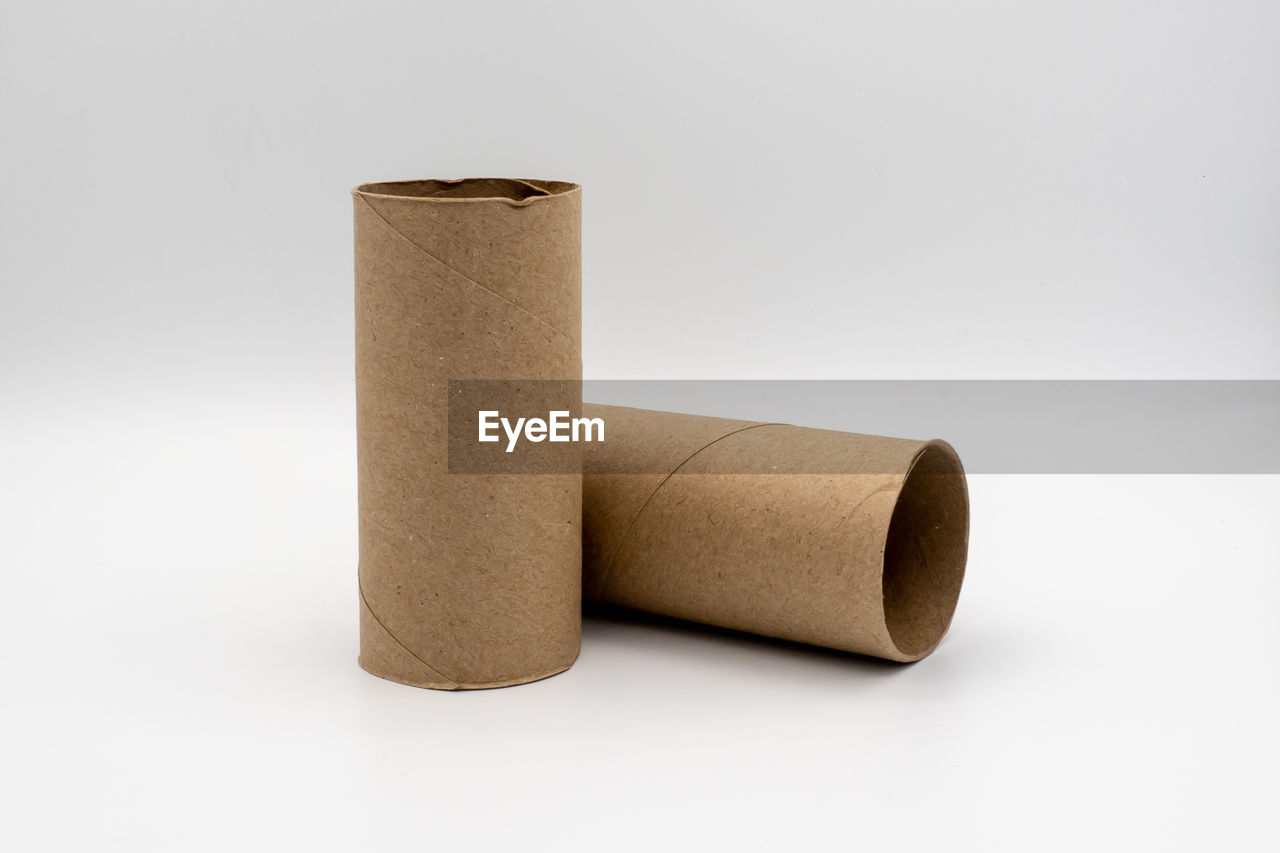 Close-up of rolled cardboard over white background