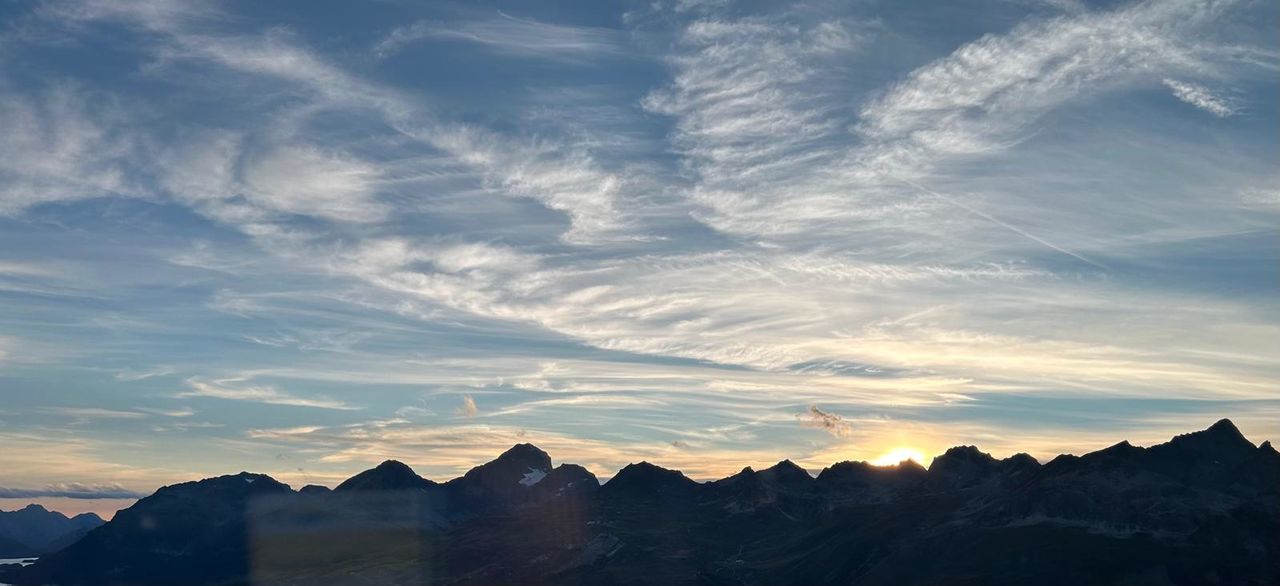 sky, mountain, cloud, scenics - nature, landscape, environment, horizon, mountain range, beauty in nature, dawn, nature, sunrise, sunlight, travel destinations, travel, mountain peak, morning, no people, tranquility, dramatic sky, tranquil scene, outdoors, land, blue, tourism, sun, architecture, cloudscape, idyllic, silhouette, rock, non-urban scene, awe, twilight