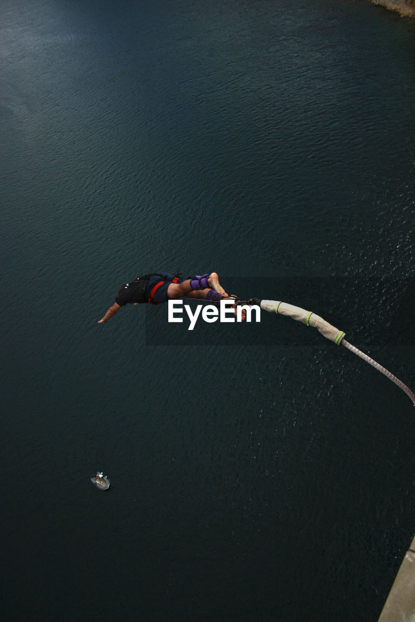 Bungee jumping over calm sea