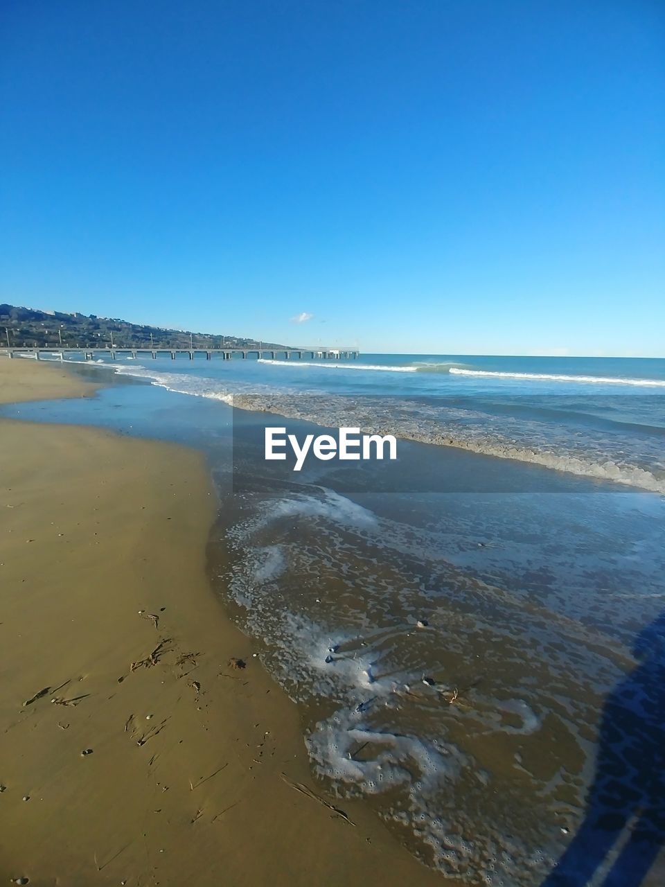 PANORAMIC VIEW OF BEACH AGAINST CLEAR BLUE SKY