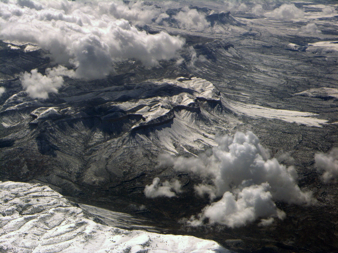 AERIAL VIEW OF SNOW CAPPED MOUNTAINS
