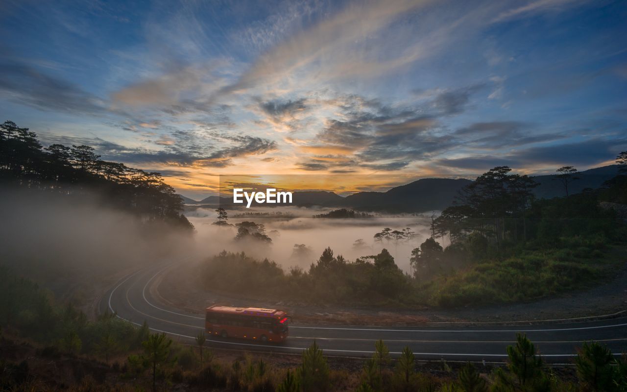 High angle view of bus on road against landscape and sky during sunset