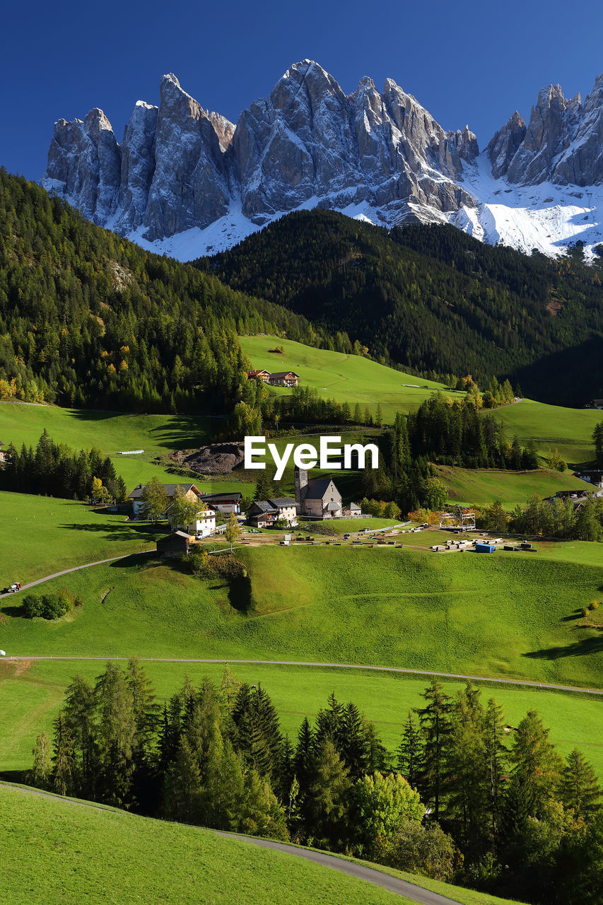 Scenic view of field and mountains against sky