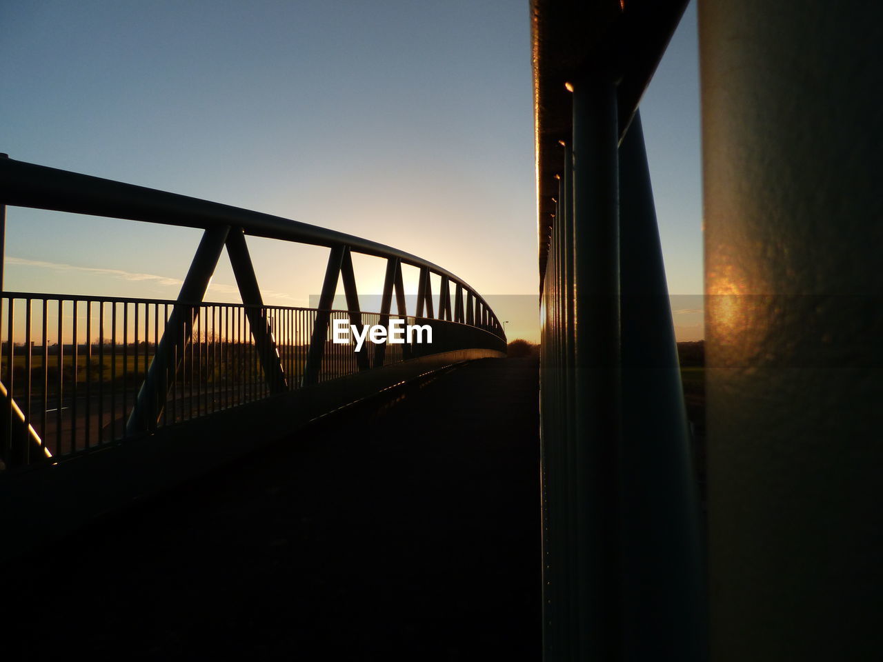 SILHOUETTE BRIDGE AGAINST SKY AT SUNSET