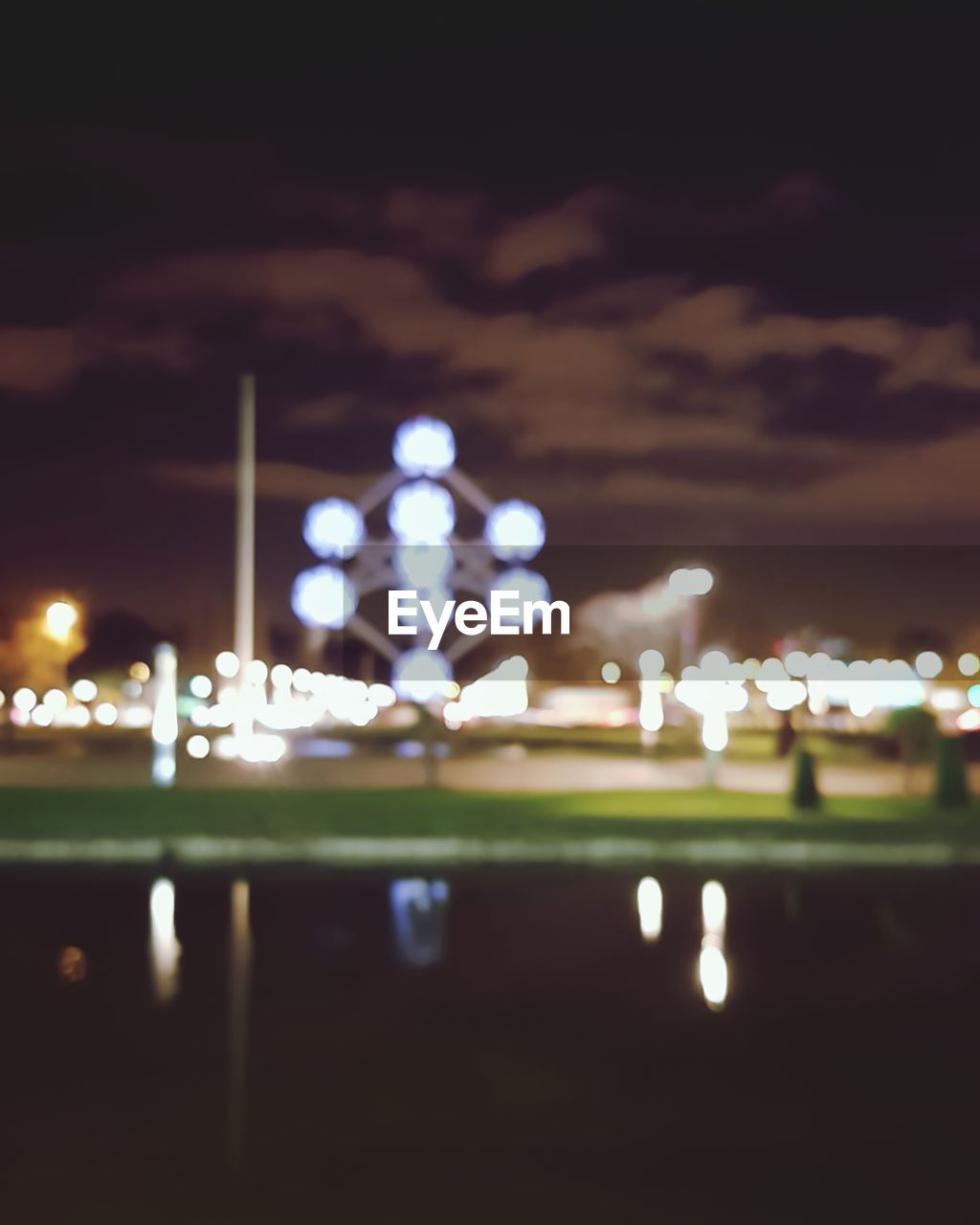VIEW OF ILLUMINATED CITY AGAINST SKY