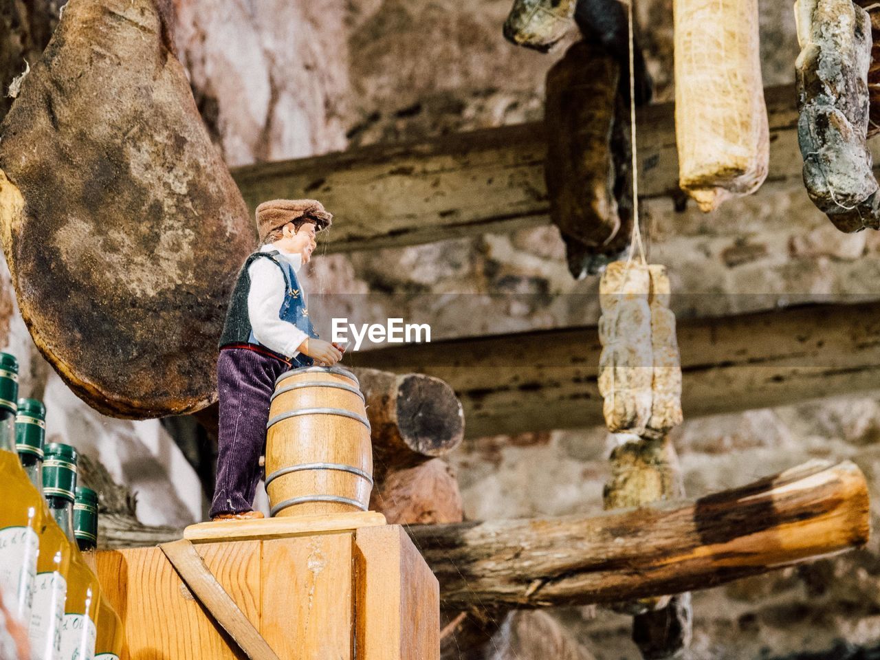 WOMAN WORKING ON WOODEN STRUCTURE