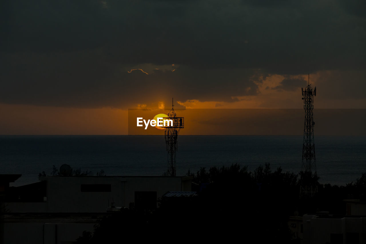 Sunset over the ocean in the village of albion, mauritius.