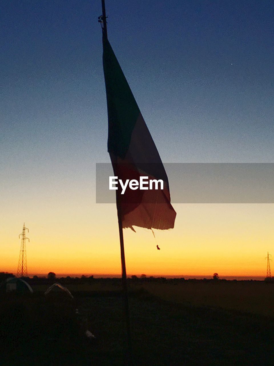 CLOSE-UP OF UMBRELLA AGAINST SKY DURING SUNSET